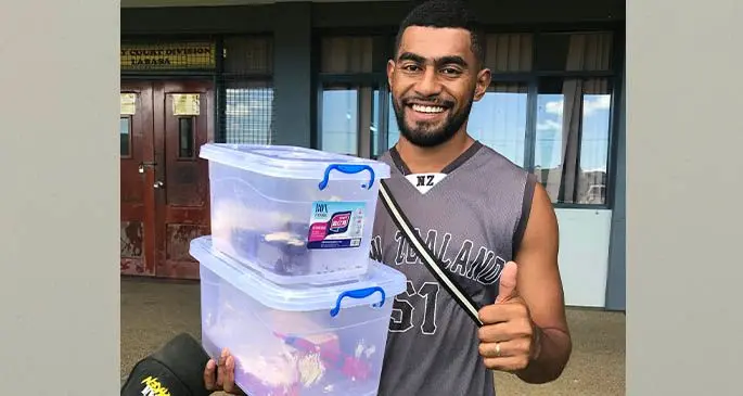 Manasa Tudama Vukivuki with his containers of homemade cakes. Photo: Laisa Lui.