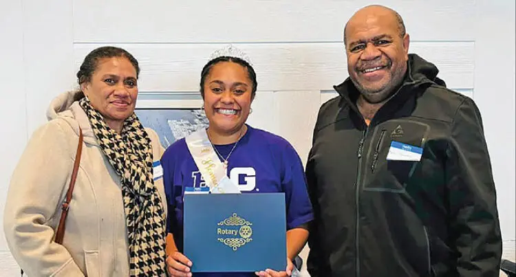 Deborah Selenia Vasuilakeba pictured smiling and standing between her aunt Selenia and uncle Aseri Kunawave.
