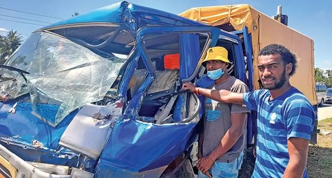 Anisi Tokomai (right) and another passenger with their wrecked truck that was involved in an accident at the Nawaka Junction in Nadi on October 26, 2021. Photo: Mereleki Nai