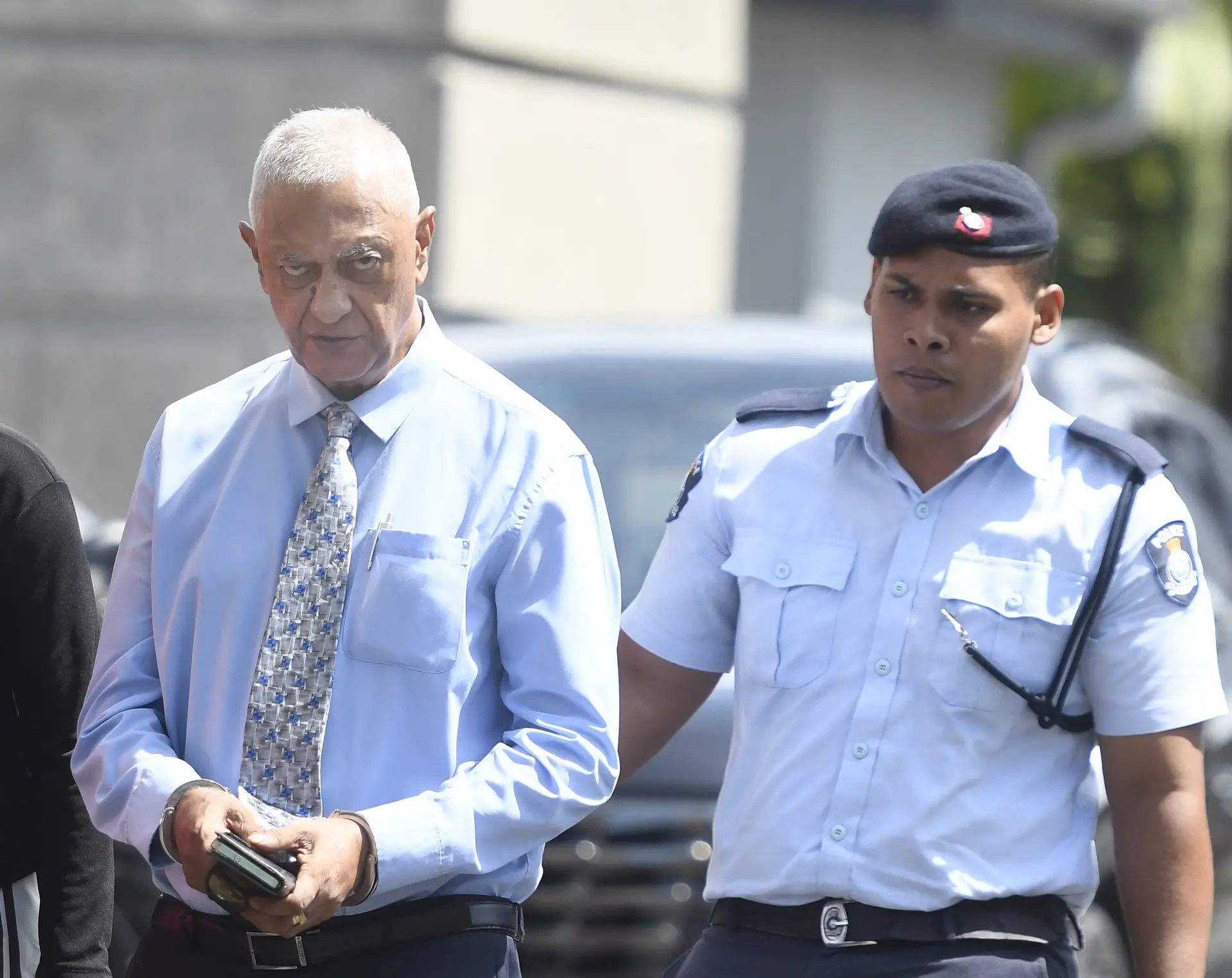 Former lawyer Shazran Abdul Lateef escorted by a police officer after his sentencing on February 23, 2026.