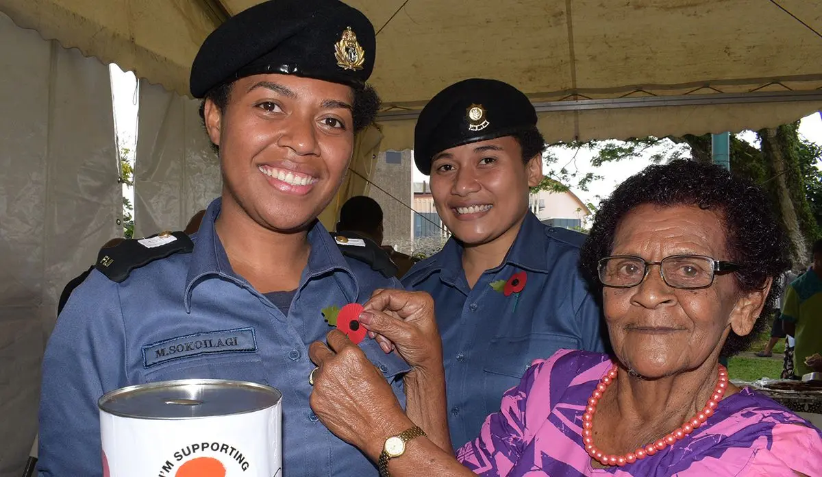 Ecela Vakacokaivalu (right) member of ex-serviceman association pin, the Poppy flowers to MID Meresaini Sokoilagi and OS Jenny Waqa following the launching of Poppy Appeal by President Jioji Konrote and Acting Prime Minister and Minister for Fisheries Semi Koroilavesau at Ratu Sukuna Park on October 4, 2019.Photo: Ronald Kumar.