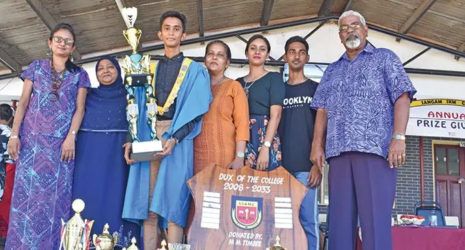  Sangam Sadhu Kuppuswamy Memorial College (SSKMC) Dux, Kaveet Kavitesh Kumar, (holding trophy) with family members and school management in Nadi. Photo: Mereleki Nai