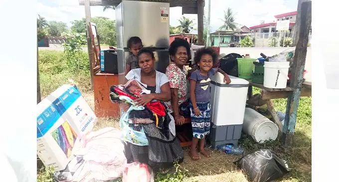 The family with their belongings sheltering at a bus shelter in Navo, Nadi.