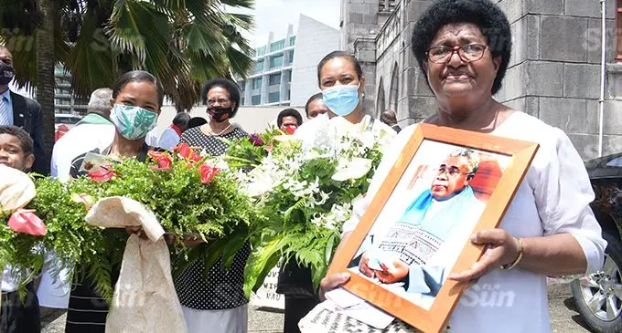 Ani Naivalu (right), widow of the late Methodist Church general secretary, Reverend Iliesa Naivalu with his picture after the funeral service at Centenary Church in Suva on December 29, 2021. Photo: Ronald Kumar
