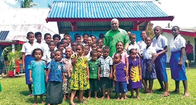 Prime Minister Voreqe Bainimarama with the students of Nacavanadi Village School.  Photo: Kelera Sovasiga
