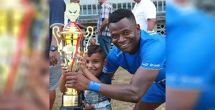 United Sangam FC striker Usman Omede with a young supporter with the Digicel National Club Championship title at Lawaqa Park, Sigatoka, on January 29, 2023. Photo: Fiji FA Media