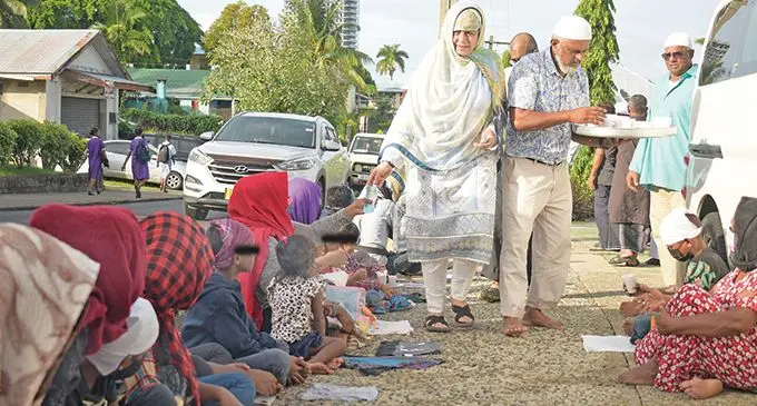 Members of the Muslim community offer cash and Samai drinks to the underprivileged outside the Toorak Jame Mosque as they celebrated Eid on May 3, 2022.  Photo: Ronald Kumar