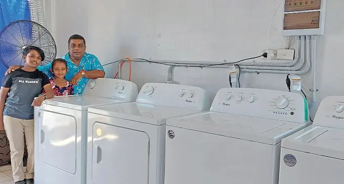 Quick Clean Laundry Services director, Mohammed Alfaz Khan with his daughter, 11-year-old, Dilera Zeba (left) and seven-year-old niece, Zaheerah Muskaan inside the newly-opened laundry business in Lautoka on December 2, 2022. Photo: Nicolette Chambers