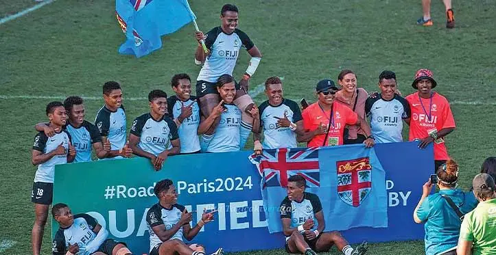 Veteran Fiji Airways Fijiana rugby sevens forward Reijeli Daveua with the national flag, carried by Verenaisi Bari and surrounded by team-mates after beating Papua New Guinea 54-0 at the Ballymore Stadium in Brisbane, Australia, on November 12, 2023. The Fijiana side has qualified for the 2024 Olympic Games in Paris, France. Photo: Pita Tagicakiverata