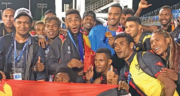 Banuve Tabakaucoro shows his gold medal for winning the men’s 200m final, as he joins the Papua New Guinea athletes at Apia Park, Samoa on July 18, 2019. Photo: Rosi Doviverata