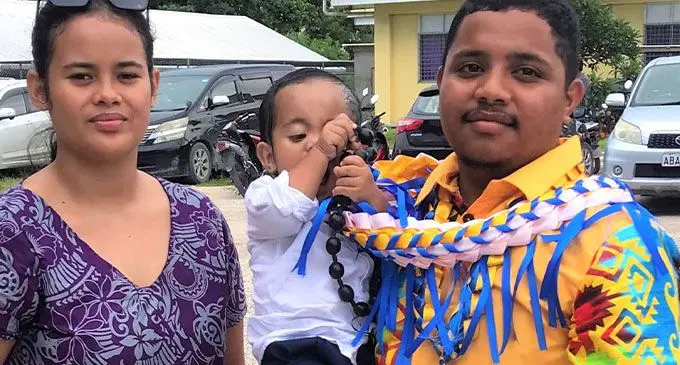 Issachar Adu (right),wearing a shirt sewn during the short course, with his family at the graduation ceremony.