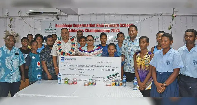 Ram Bhajo Supermarket director Rajnil Kumar (with garland) with Team Nadi Primary Athletics squad and teachers during their sponsorship presentation. Photo: Waisea Nasokia