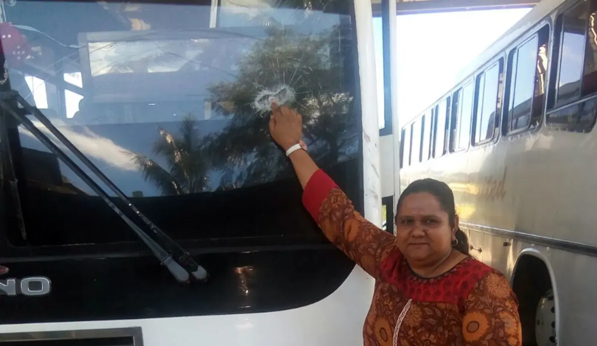 Khans Buses Limited’s operation manager Ramiza Begum with one of the company’s buses that was stoned.  Photo: Nicolette Chambers  