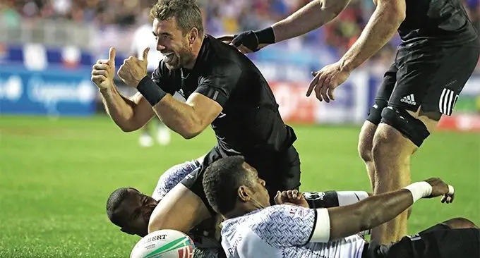Veteran New Zealand 7s playmaker Kurt Baker celebrates scoring the winning try in the Cup quarterfinal of the USA 7s while Fiji Airways Fijian 7s forwards Josua Vakurinabili and Kalione Nasoko look on. New Zealand won 19-14. but Baker will not play because of an injury and has returned to New Zealand. Photo: World Rugby
