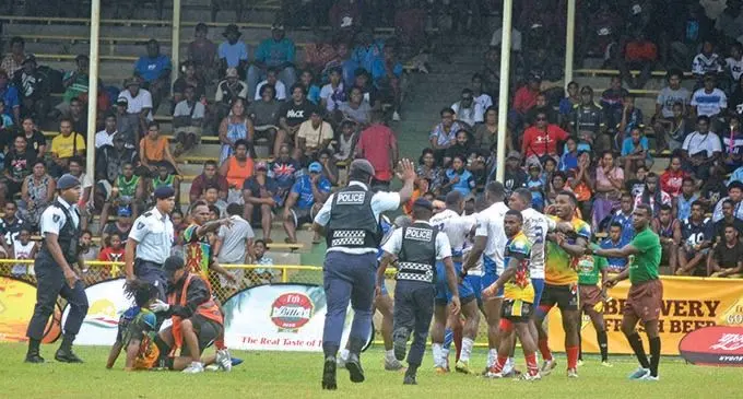 Police reps warned... Police officers run in when a brawl erupted between Police White and Raiwasa Taveuni players during the Cup quarterfinal of the Fiji Bitter Nawaka 7s on February 27, 2021. Raiwasa Taveuni won 17-0.. Photo: Waisea Nasokia.