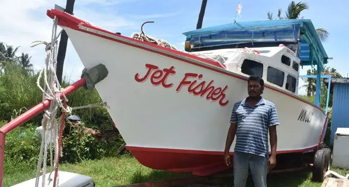 Abdul Aiyaz Khan standing beside the newly built Jet Fisher.