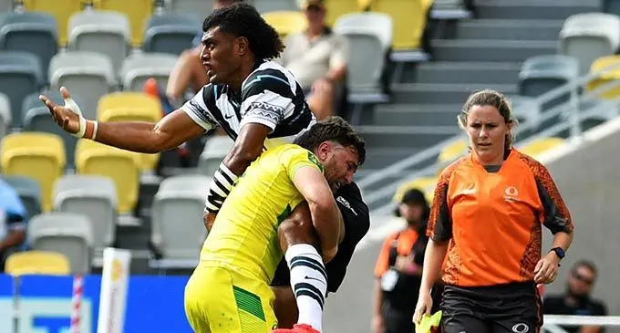 Fijian men’s 7s forward Taniela Sadrugu offloads the ball despite a tackle from veteran Australia 7s forward Lewis Holland at the Queensland Country Bank Stadium in Townsville. Photo: Oceania Rugby