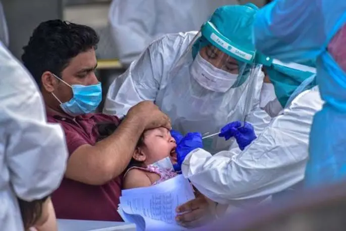 A medical staff member takes samples of a child at a COVID-19 testing point in Kuala Lumpur, Malaysia, April 15, 2020. (Photo by Chong Voon Chung/Xinhua)