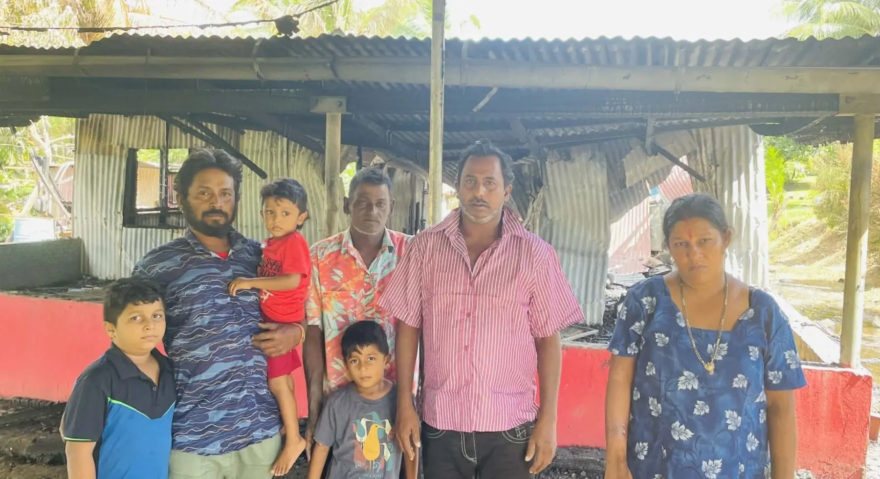 Parmit Shalendra Prasad (first from left) and his family stand in front of their destroyed home at Votualevu in Nadi. Photo: Katherine Naidu