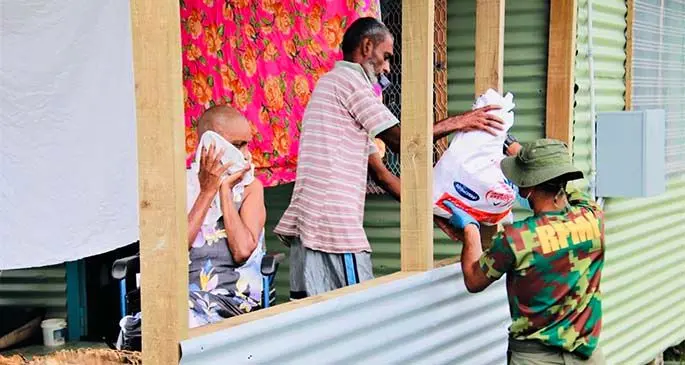 Republic of Fiji Military personnel delivering a food pack to a family along Khalsa Road in Nasinu on May 2, 2021. Photo: Ministry of Health and Medical Services