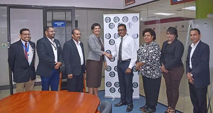Permanent Secretary, Office of the Prime Minister and Immigration Mr Yogesh Karan congratulates newly-appointed acting Director for Immigration Ms Amelia Komaisavai and is joined by Immigration executive officials.