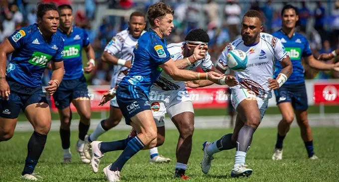 Swire Shipping Fijian Drua  wing Eroni Sau hunts down Auckland Blues Beauden Barrett during their Super Rugby Culture round match at Lautoka's Churchill Park.  Photo- Leon Lord 