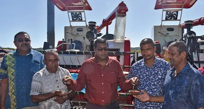 Minister for Agriculture,Mahendra Reddy (centre) hands over the keys to mechanical rice harvesters in Dreketi, Macuata, on June 9, 2022. Photo: Ministry of Agriculture
