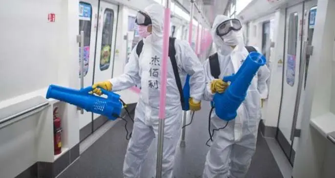 Staff members conduct disinfection on the subway train at a train depot in Wuhan, central China's Hubei Province, March 23, 2020. (Xinhua/Xiao Yijiu)