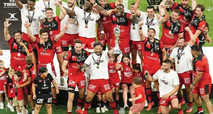 Lyon rugby players with Josua Tuisova after winning their first European title at the Stade Velodrome, this morning. Photo: Planet Rugby 