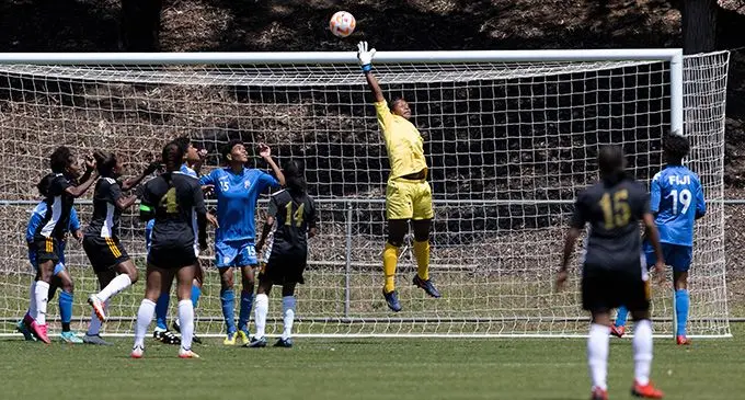 Merevesi Fuga (wearing yellow outfit) makes a save for the Digicel Fijian Kula in the Pacific Women's Four Nations tournament Photo: Football Australia.