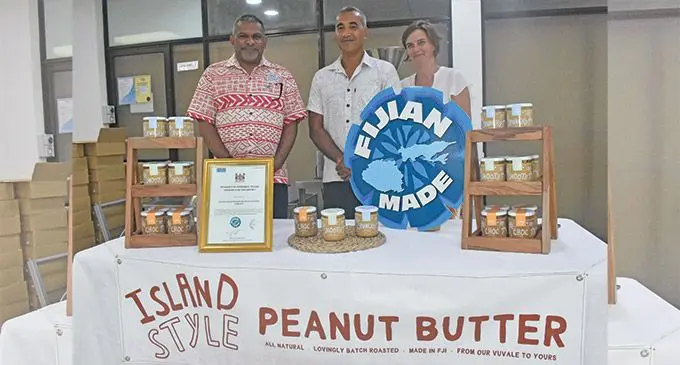 Minister for Commerce, Trade, Tourism and Transport, Faiyaz Koya (left) congratulating the owners of Island Style Coconut Peanut Butter Fiji, Gary Pickering and Heather Pickering for joining the Fijian Made family.