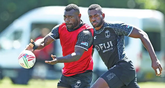 Fiji Airways Fijian 7s forwards Asaeli Tuivuaka delivers a pass while Sevuloni Mocenacagi closes in during training in London on May 19, 2019.  Photo: World Rugby
