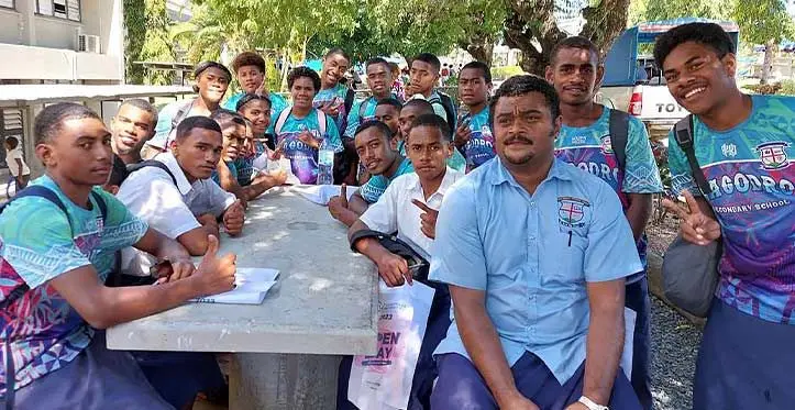 Isikeli Navuni (right) with the students of Magodro Secondary School.