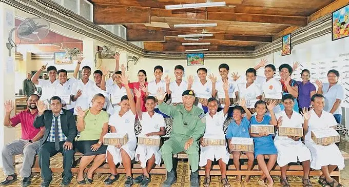 Republic of Fiji Military Forces Commander Rear Admiral Viliame Naupoto (sitting, sixth from left), with students who received a pair of shoes and uniform and teachers and officials at Labasa College on March 1, 2021. .  Photo: Laisa Lui