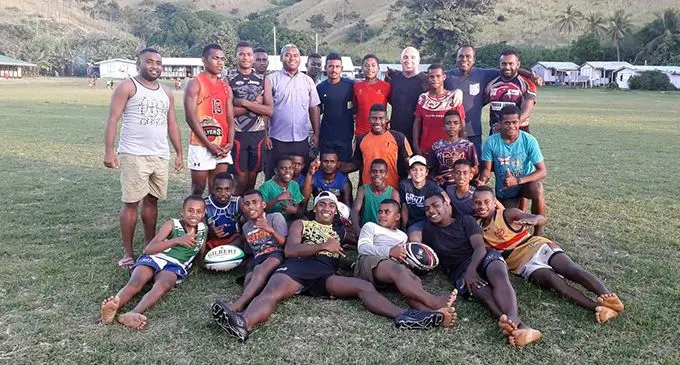 Vodafone Fijian Bati head coach Brandon Costin (standing fourth from right) with students and teachers of Yasawa North College. Photo: Joe Natinavou 