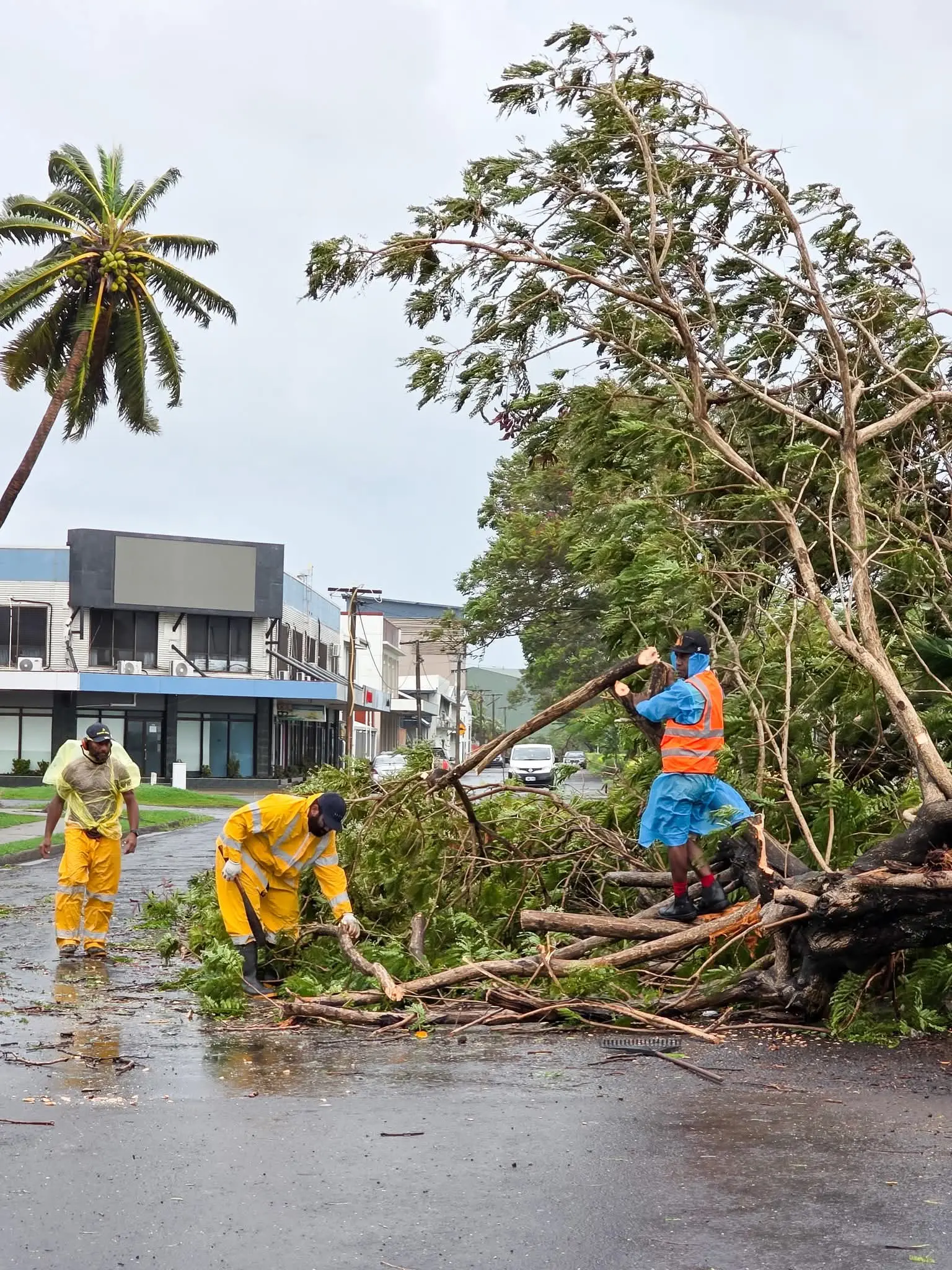 Staff of LCC clearing the road in Lautoka city.