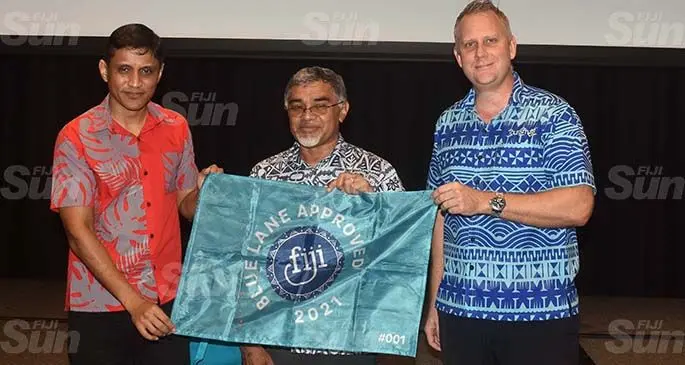 COVID-19 Risk Mitigation Taskforce team members, Permanent Secretary for Ministry of Commerce, Trade and Tourism Shaheen Ali and Permanent Secretary for Health and Medical Services, Dr James Fong receive the flag from Tourism Fiji chief operations officer James Pridgeon during the Tourism Talanoa session held at the Sofitel Fiji Resort & Spa on Denarau on March 5, 2021. Photo: Waisea Nasokia