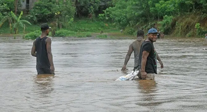 People wade in flooded waters at Navutu Village in Nadroga on February 10,m 2018. Photo: Arieta Vakasukawaqa 