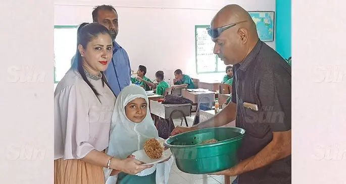 (Right) Abdul Nazim and his wife Naazrin Nisha and Wairabetia Muslim Primary School head teacher Munir Shah provide lunch to a student Zanaira Nisha on August 13,2020. Photo: Salote Qalubau