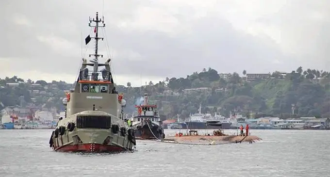 The sunken vessel MV Southern Phoenix being towed out of Suva Harbour.