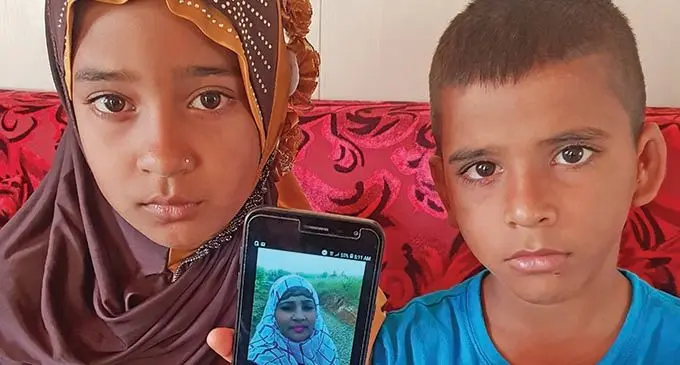 The children of the late Shabina Nisha, Ghazala Nisha (left) and Mohammed Zahid Zaim (right) show a photo of their mother.  Photo: Nicolette Chambers 