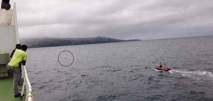 The rescue team approaches the man. The rescue team returns to the ship safely with Mr Vuataki.