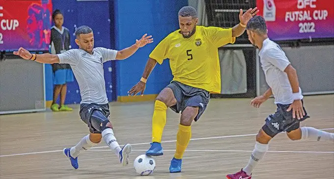 Vanuatu’s Kevin Donald tries to maintain possession against Shahil Dave (left) during the plate final match of the OFC Futsal Cup at the Vodafone Arena, Suva on September 18, 2022. Photo: Leon Lord