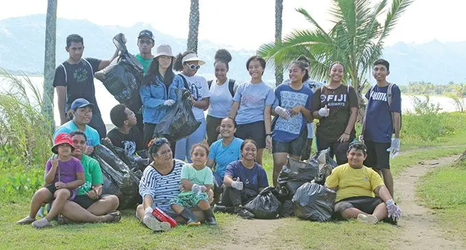 Teen activist AnnMary Raduva (left with blue cap) with family members and classmates at the Wailoaloa Beach clean up in Nadi on June 4, 2022. 
