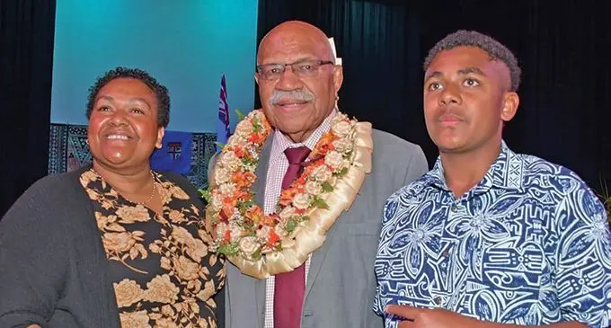 Prime Minister Sitiveni Rabuka meets Fijians, Savaira Tagi and son Sakeasi at Sunnybank, Brisbane on Thursday night. Ms Tagi is a nurse at the Gold Coast Hospital  .  Photo: DEPTFO
