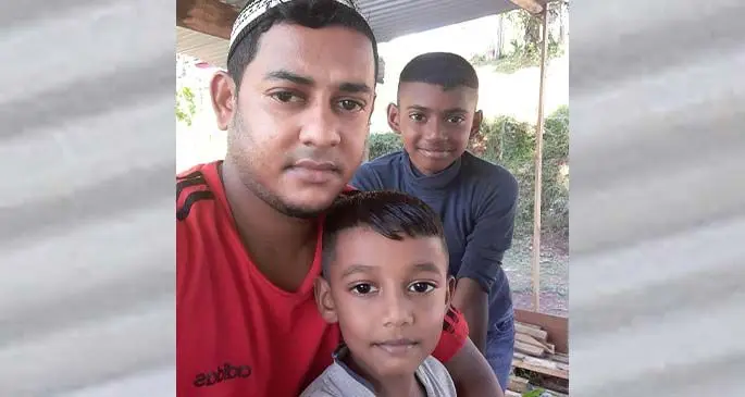 Imu Imran and his two sons outside their home on May 3, 2020