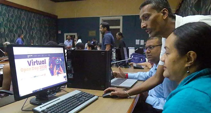 FNU Senior ICT support officer, Kamlesh Prasad assisting Moto Ahopo and Vinay Nand from the Finance Team during the Virtual Open Day on August 17, 2020.  Photo: Kelera Sovasiga