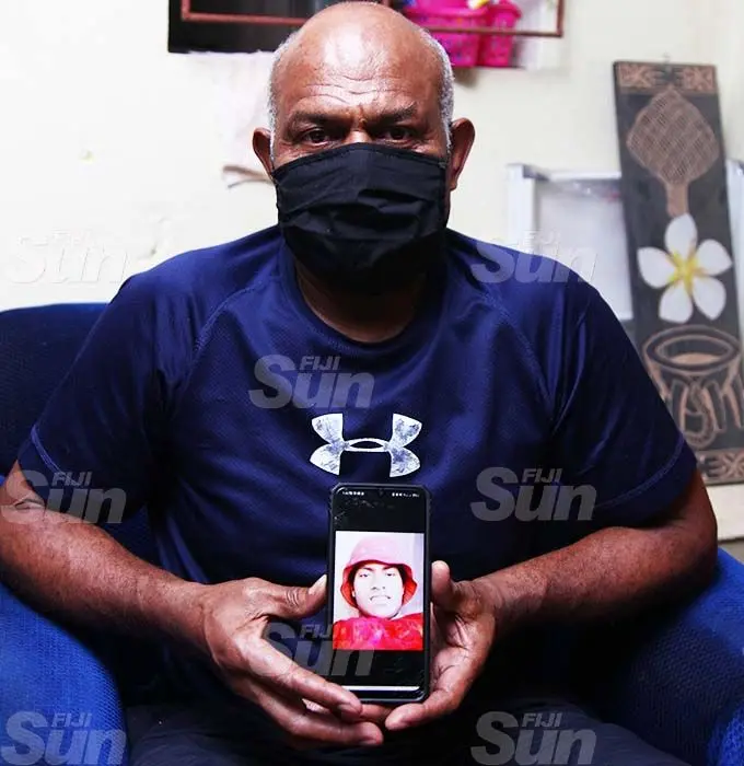 An emotional Suliasi Wasakitoga holding a photo of his son Luke Sulinibau at their home in Raiwaqa on September 5, 2021. Photo: Leon Lord