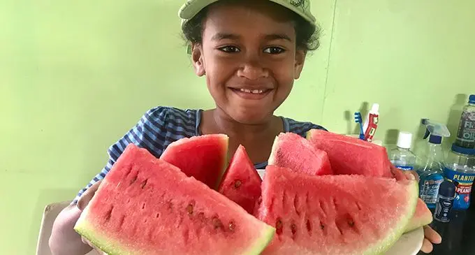 Fani Cheer’s daughter Faith with the first water melon at the farm in Karavi on August 22 on August 22, 2019. Photo: Charles Chambers