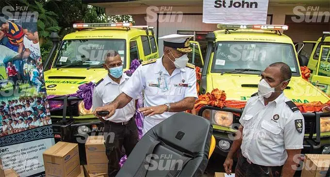 Saint John Ambulance staff Ratu Esira Naikatolu (left) and Vuli Vakatoto brief the Commander of the Republic of Fiji Military Forces Rear Admiral Viliame Naupoto during the handover in Toorak on August 9, 2021. Photo: Leon Lord.